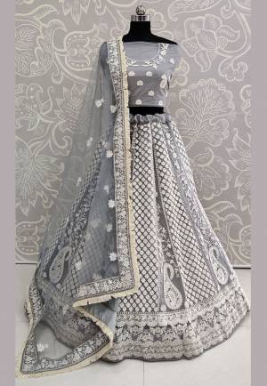 Flaunt Your Rich And Elegant In This New Patterned Heavy Designer Lehenga Choli In Grey Color. Its Heavy Embroidered Blouse, Lehenga And Dupatta Are Fabricated On Net Beautified With White Colored Thread Embroidery Giving An Attractive Look. 