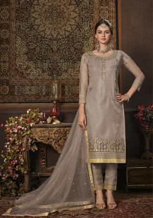 This Season Is About Subtle Shades And Pastel Play, So Grab This Heavy Designer Straight Suit In Light Grey Color. Its Top Is Net Based Paired With Soft Silk Bottom And Net Fabricated Dupatta. It Top Is Beautified With Attractive All Over Embroidery. 
