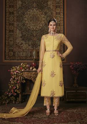 Look Pretty In This Beautiful Designer Straight Suit In Yellow Color. Its Top Is Fabricated On Net Paired With Soft Silk Bottom and Net Fabricated Dupatta. It Is Beautified With Attractive Embroidery. 