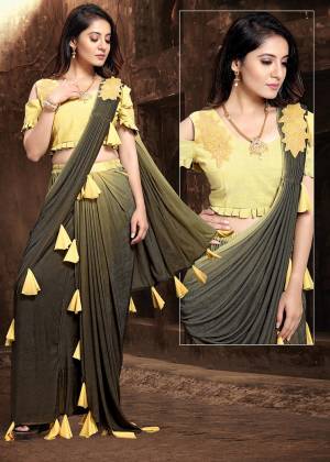 Get Ready For The Upcoming Wedding Season Wearing This Ready To Wear Saree In Black And Yellow Color. This Saree And Blouse Are Fancy Fabric Based Beautified With Tassels And Patch Work. 