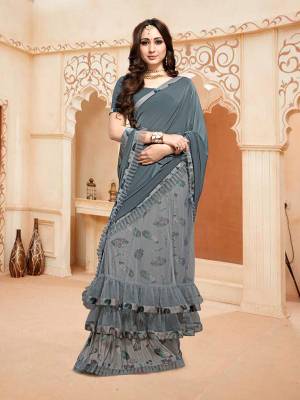 Here Is An Elegant Designer Saree In Grey Color Paired With Grey Colored Blouse. This Saree And Blouse Are Fabricated On Fancy Fabric. This Designer Piece Is Ready To Wear Saree Which Is Easy To Carry All Day Long, 