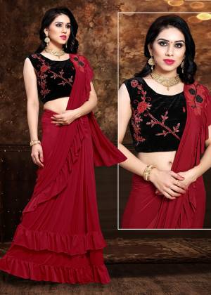 Here Is An Elegant Designer Saree In Red Color Paired With Black Colored Blouse. This Saree And Blouse Are Fabricated On Fancy Fabric. This Designer Piece Is Ready To Wear Saree Which Is Easy To Carry All Day Long, 
