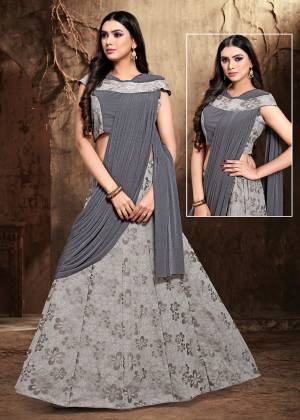 Get Ready For The Upcoming Wedding Season Wearing This Designer Saree In Grey Color. This Saree And Blouse Are Fancy Fabric Based Beautified With Fancy Work.  This Ready To Wear Saree Is Given A Beautiful Lehenga Pattern.