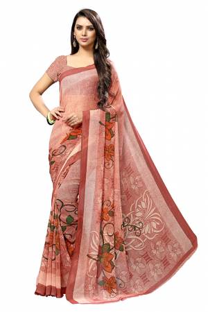 Simple And Elegant Looking Saree Is Here For Your Casual Or Semi-Casual Wear In Peach Color. This Pretty Saree And Blouse Are Chiffon Based Beautified With Prints All Over. 