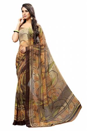 Here Is A Very Pretty Saree In Brown Color Fabricated On Chiffon. This Pretty Saree Is Beautified With Prints And It Is light In Weight Which Ensures Superb Comfort All Day Long. 