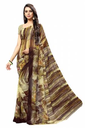 Simple And Elegant Looking Saree Is Here For Your Casual Or Semi-Casual Wear In Brown Color. This Pretty Saree And Blouse Are Chiffon Based Beautified With Prints All Over. 