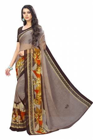 Here Is A Very Pretty Saree In Light Brown Color Fabricated On Chiffon. This Pretty Saree Is Beautified With Prints And It Is light In Weight Which Ensures Superb Comfort All Day Long. 