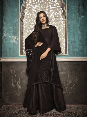 For A Bold And Beautiful Look, Grab This Designer Floor Length Suit In Dark Brown Color Paired With Black Colored Dupatta. Its Top Is Fabricated On Art Silk Paired With Santoon Bottom And Brasso Dupatta. Its Bold Color And Attractive Brasso Pattern Will Earn You Lots Of Compliments From Onlookers. 