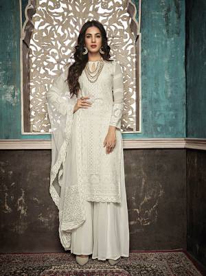 Flaunt Your Rich And Simple Look In This Very Subtle White Colored Designer Lakhnavi Suit. Its Top And Bottom Are Fabricated On Georgette Paired With Net Fabricated Dupatta. It Is Beautified With White Colored Tone To Tone Embroidery Giving A Rich Look To The Suit.