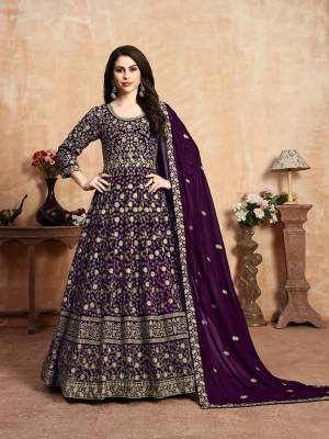 Get Ready For The Upcoming Wedding Season With This Heavy Designer Floor Length Suit In Dark Purple Color. Its Heavy Embroidered Top Is Fabricated On Georgette Paired With Santoon Bottom And Georgette Fabricated Dupatta Which Has Pretty Elegant Embroidered Buttis And Lace Border. 