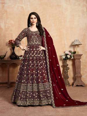 Get Ready For The Upcoming Wedding Season With This Heavy Designer Floor Length Suit In Maroon Color. Its Heavy Embroidered Top Is Fabricated On Georgette Paired With Santoon Bottom And Georgette Fabricated Dupatta Which Has Pretty Elegant Embroidered Buttis And Lace Border. 