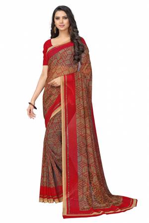 Here Is A Very Pretty Saree In Red And Brown Color Fabricated On Chiffon.?This Pretty Saree Is Beautified With Prints And It Is light In Weight Which Ensures Superb Comfort All Day Long.