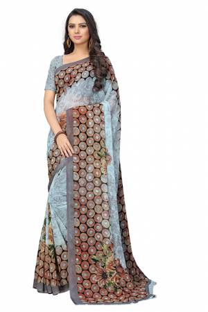 Here Is A Very Pretty Saree In Light Blue Color Fabricated On Chiffon.?This Pretty Saree Is Beautified With Prints And It Is light In Weight Which Ensures Superb Comfort All Day Long.