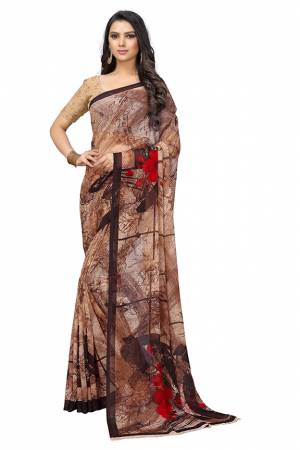 Simple And Elegant Looking Saree Is Here For Your Casual Or Semi-Casual Wear In Brown Color. This Pretty Saree And Blouse Are Chiffon Based Beautified With Prints All Over.