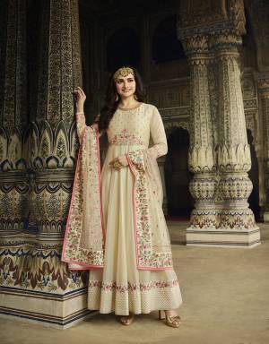 Flaunt Your Rich And Elegant Taste Wearing This Heavy Designer Floor Length Suit In Cream Color. Its Embroidered Top Is Fabricated On Soft Silk Paired With Cotton Satin Bottom And Heavy Embroidered Net Fabricated Dupatta. All Its Fabrics Are Soft Towards Skin And Ensures Superb Comfort Throughout The Gala.