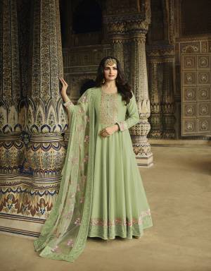 Here Is A Pretty Suit For The Upcoming Wedding And Festive Season In Light Green Color. Its Pretty Floor Length Top Is Fabricated On Soft Silk Paired With Cotton Satin Bottom And Net Fabricated Dupatta. Its Attractive Part Is Its Beautifully Heavy Embroidered Dupatta. 