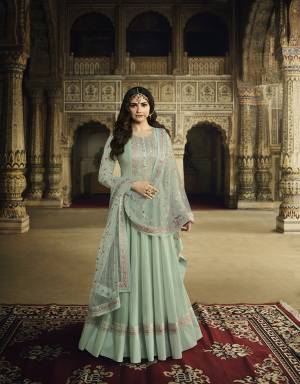 Pretty Shade Is Here To Add Into Your Wardrobe With This Designer Floor Length Suit In Aqua Blue Color. Its Top Is Fabricated On Soft Silk Paired With Cotton Satin Bottom and Net Fabricated Dupatta. Buy Now. 