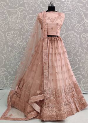 Look The Most Elegant Of All This Wedding Season Wearing This Heavy Designer Lehenga Choli In Light Peach Color. This Beautiful Heavy Tone To Tone Embroidered Lehenga Choli Is Fabricated On Net. Its Rich Color and Detailed Embroidery Will earn You Lots Of Compliments From Onlookers