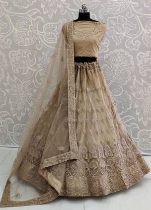 Look The Most Elegant Of All This Wedding Season Wearing This Heavy Designer Lehenga Choli In Beige Color. This Beautiful Heavy Tone To Tone Embroidered Lehenga Choli Is Fabricated On Net. Its Rich Color and Detailed Embroidery Will earn You Lots Of Compliments From Onlookers