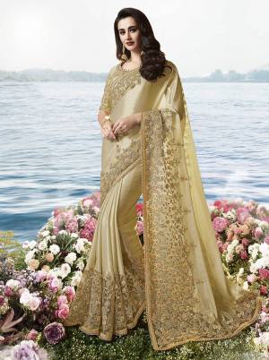 Flaunt Your Rich And Elagant Taste Wearing This Pretty Designer Saree In Cream Color Paired With Cream Colored Blouse. This Elegant Tone To Tone Embroidered Designer Saree Is Fabricated on Tissue Silk Paired With Art Silkn Fabricated Blouse. Buy This Rich Looking Saree Now.