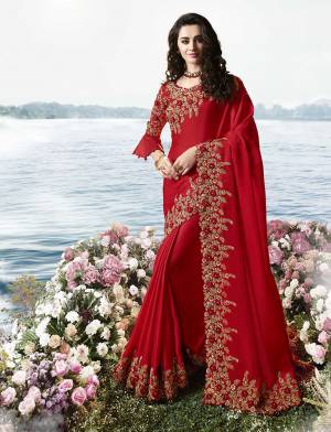 Adorn The Pretty Angelic Look In Bold And Beautiful Heavy Designer Saree In Red Color Paired With Red Colored Blouse. This Pretty Saree Is Silk Georgette Based Paired With Art Silk And Net Fabricated Blouse. 