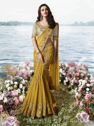 Celebrate This Festive Season Wearing This Heavy Designer Lehenga Style Saree In Musturd Yellow Color Which Has Separate Skirt and Pallu Paired With Cream Colored Blouse. This Pretty Skirt And Pallu Are Soft Silk Based Paired With Art Silk And Net Fabricated Blouse. Buy Now. 