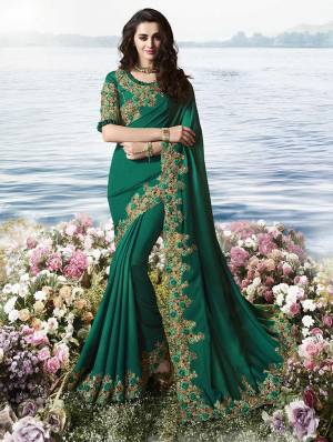 Here Is An Attractive Looking Lace Embroidered Designer Saree In Dark Teal Green Color Paired With Dark Teal Green Colored Blouse. This Saree Is Fabricated On Satin Silk Paired With Art Silk And Net Fabricated Blouse. 
