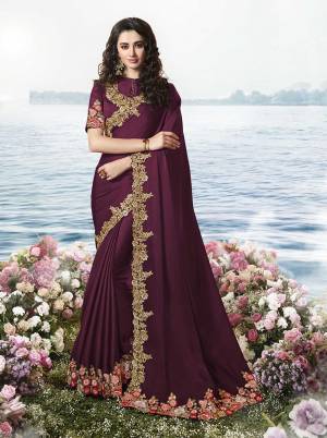 Here Is An Attractive Looking Lace Embroidered Designer Saree In Wine Color Paired With Wine Colored Blouse. This Saree Is Fabricated On Satin Silk Paired With Art Silk And Net Fabricated Blouse. 
