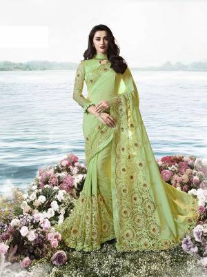 Look Pretty In This  Heavy Designer Saree In Green Color Paired With Green Colored Blouse. This Saree Is Fabricated On Soft Silk Paired With Art Silk And Net Fabricated Blouse. It Is Beautified With Heavy Embroidered Attractive Lace Border. 