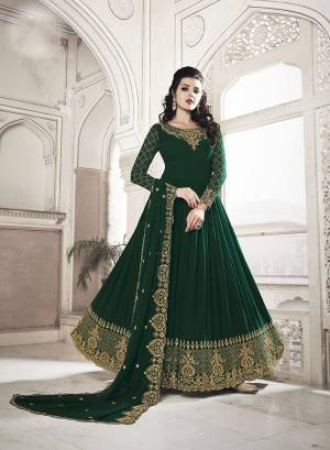 For The Upcoming Wedding And Festive Season, Grab This Heavy Designer Floor Length Suit In Dark Green Color. Its Heavy Embroidered Top and Dupatta Are Fabricated On Georgette Paired With Soft Silk Bottom. Buy Now.