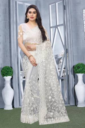 Here Is A Pretty Elegant Looking Heavy Designer Saree In White Color. This Saree And Blouse Are Fabricated On Net Beautified With Tone To Tone Embroidery All Over. Buy Now.