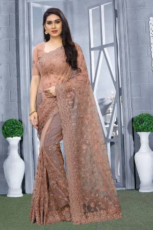 Here Is A Pretty Elegant Looking Heavy Designer Saree In Dusty Pink Color. This Saree And Blouse Are Fabricated On Net Beautified With Tone To Tone Embroidery All Over. Buy Now.