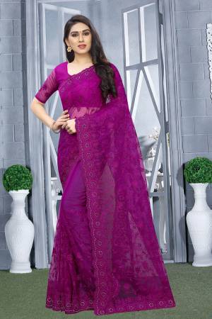 Here Is A Pretty Elegant Looking Heavy Designer Saree In Purple Color. This Saree And Blouse Are Fabricated On Net Beautified With Tone To Tone Embroidery All Over. Buy Now.