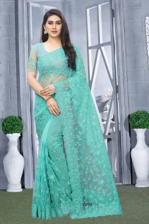 Here Is A Pretty Elegant Looking Heavy Designer Saree In Turquoise Blue Color. This Saree And Blouse Are Fabricated On Net Beautified With Tone To Tone Embroidery All Over. Buy Now.