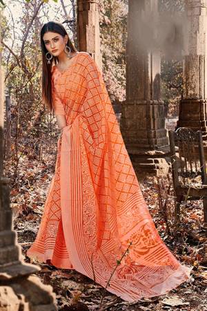 Here Is A Pretty Designer Saree In Orange Color For The Upcoming Festive Season. This Saree Is Fabricated on Cotton Brasso Paired With Art Silk Fabricated Blouse. Its Rich Fabric Will Definitely Earn You Lots Of Compliments From Onlookers. 
