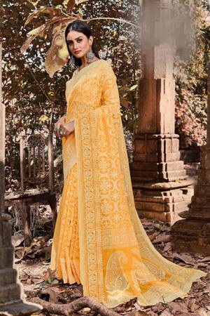 Add This Beautiful Cotton Based Designer Saree To Your Wardrobe In Yellow Color. This Saree Is Fabricated On Cotton Brasso Paired With Art Silk Fabricated Blouse,  It Is Light Weight, Durable And Easy To Care For. 