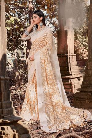 Celebrate This Festive Season With Beauty And Comfort Wearing This Pretty Saree In Beige Color. This Saree Is Cotton Brasso Based Paired With Art Silk Fabricated Blouse. It Is Light In Weight And Easy To Carry All Day Long. 