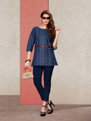 Here Is A Readymade Printed Short Kurti In Navy Blue Color Fabricated On Cotton. It Is Beautified With Prints And Available In All Regular Sizes. You Can Pair This Up With Pants Or Denim. Buy Now. 