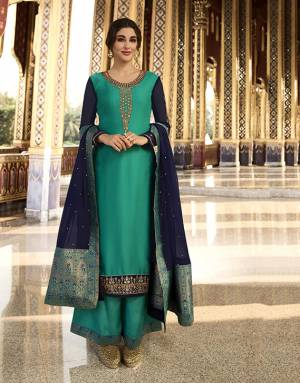 Add This Beautiful Heavy Designer Suit To Your Wardrobe In Sea Green Color Paired With Navy Blue Colored Dupatta. Its Top Is Satin Georgette Based Paired With Santoon Bottom And Chinon Fabricated Dupatta. Buy This Semi-Stitched Suit Now.