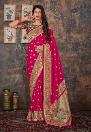 For A Proper Traditional Look, Grab This Designer Silk Based Saree In Rani Pink Color Paired With Contrasting Green Colored Blouse. This Saree And Blouse Are Fabricated On Banarasi Silk Which Also Gives A Rich Look To Your Personality. 