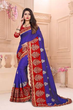 Add This Designer Embroidered Saree In Royal Blue Color Paired With Contrasting Red Colored Blouse. This Saree And Blouse Are Art Silk Based Beautified With Heavy Embroidery. 