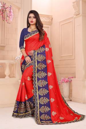 Celebrate This Festive Season With Beauty And Comfort Wearing This Designer Saree In Red Color Paired With Contrasting Navy Blue Colored Blouse. This Saree And Blouse Are Silk Based Which Gives A Rich Look To Your Personality. 