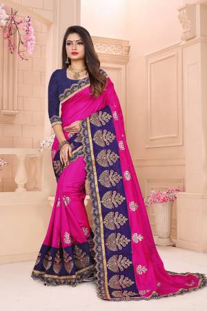 Add This Designer Embroidered Saree In Dark Pink Color Paired With Contrasting Navy Blue Colored Blouse. This Saree And Blouse Are Art Silk Based Beautified With Heavy Embroidery. 