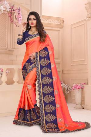 Celebrate This Festive Season With Beauty And Comfort Wearing This Designer Saree In Orange Color Paired With Contrasting Navy Blue Colored Blouse. This Saree And Blouse Are Silk Based Which Gives A Rich Look To Your Personality. 