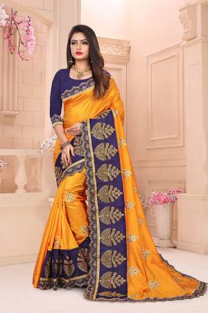 Add This Designer Embroidered Saree In Musturd Yellow Color Paired With Contrasting Navy Blue Colored Blouse. This Saree And Blouse Are Art Silk Based Beautified With Heavy Embroidery. 
