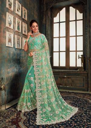 Look Pretty Wearing This Heavy Designer Saree In Green Color Paired With Green Colored Blouse. This Saree And Blouse Are Fabricated On Net Beautified With Heavy Attractive Embroidery All Over. Buy Now.