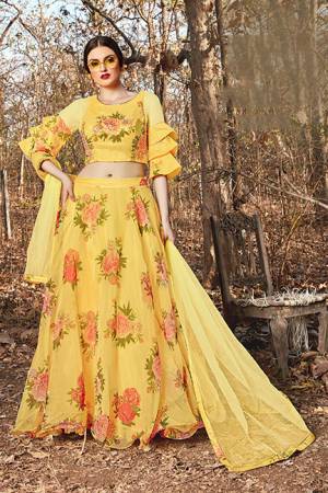 Grab This Pretty Designer Lehenga Choli In Yellow Color. Its Blouse And Lehenga Are Fabricated on Orgenza Beautified With Floral Prints Paired With Net Fabricated Dupatta. 
