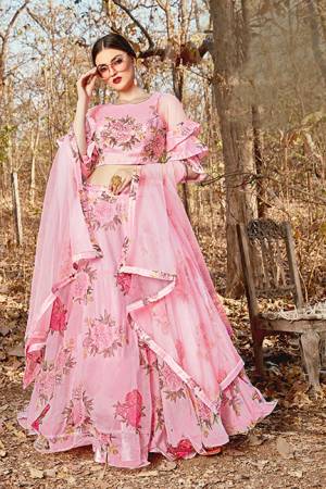 Grab This Pretty Designer Lehenga Choli In Light Pink Color. Its Blouse And Lehenga Are Fabricated on Orgenza Beautified With Floral Prints Paired With Net Fabricated Dupatta. 