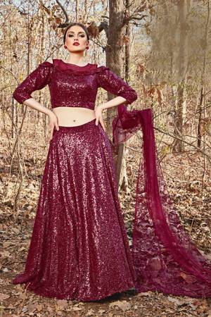 Catch All The Limelight At The Next Function You Attend Wearing This Designer Readymade Lehenga Choli In Maroon Color. Its Blouse And Lehenga Are Imported Fabric Based Paired With Net Fabricated Dupatta. 