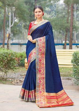 Enhance Your Personality Wearing This Designer Sare In Navy Blue Color Paired With Contrasting Red Colored Blouse. This Saree And Blouse Are Fabricated On Handloom Silk Beautified With Weave And Embroidery Over Blouse. Buy This Saree Now.